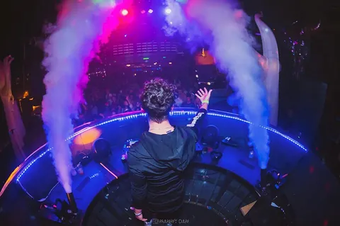 An Orion Entertainment DJ performing beneath stage lights and special effects